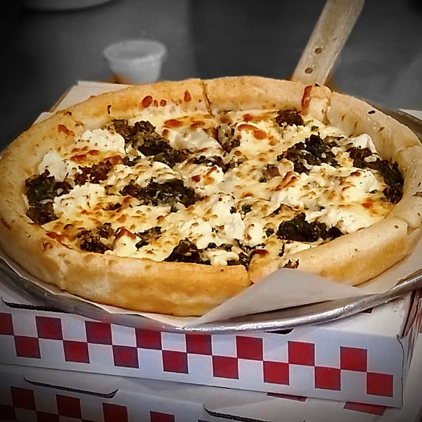 Deep-dish pizza with sausage and ricotta cheese, served in a Portofino's box.